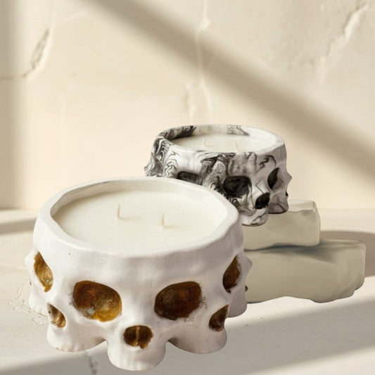 Doodlations Coffee Bar & Boutique white concrete skull candle with soy blend wax and three wicks. Textured finish.