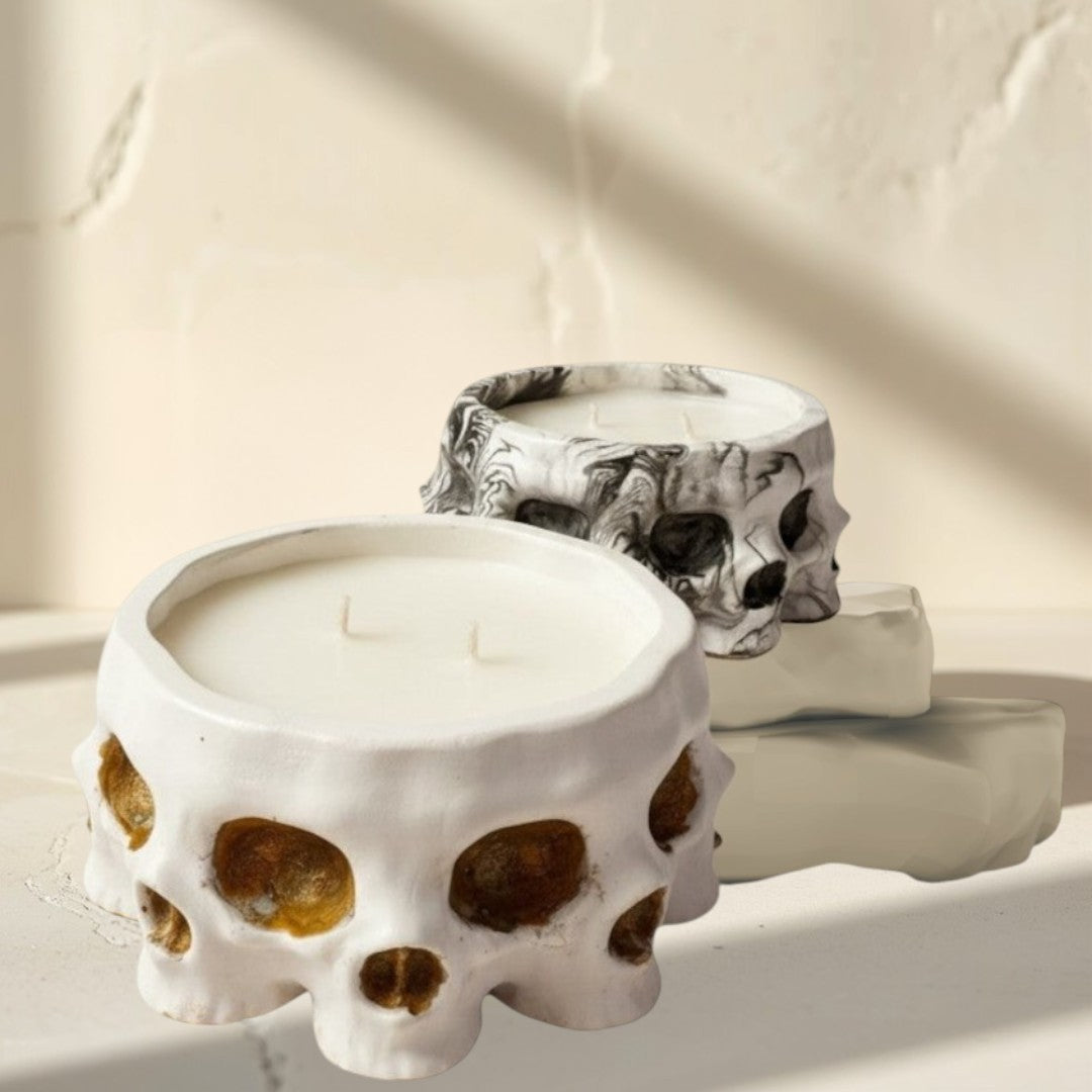 Doodlations Coffee Bar & Boutique white concrete skull candle with soy blend wax and three wicks. Textured finish.