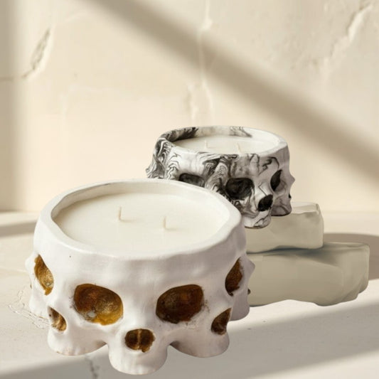 Doodlations Coffee Bar & Boutique white concrete skull candle with soy blend wax and three wicks. Textured finish.