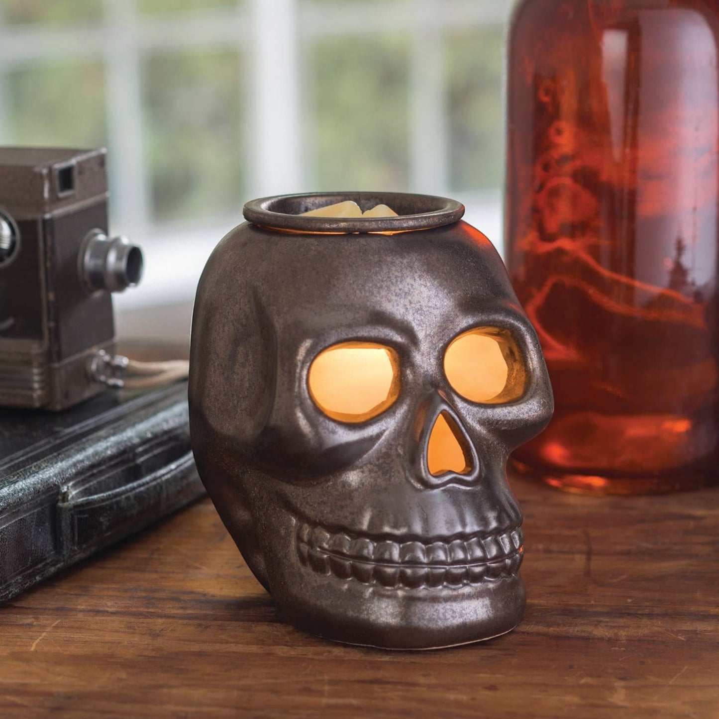 Doodlations Coffee Bar & Boutique gunmetal skull fragrance warmer with glowing eyes for gothic home decor
