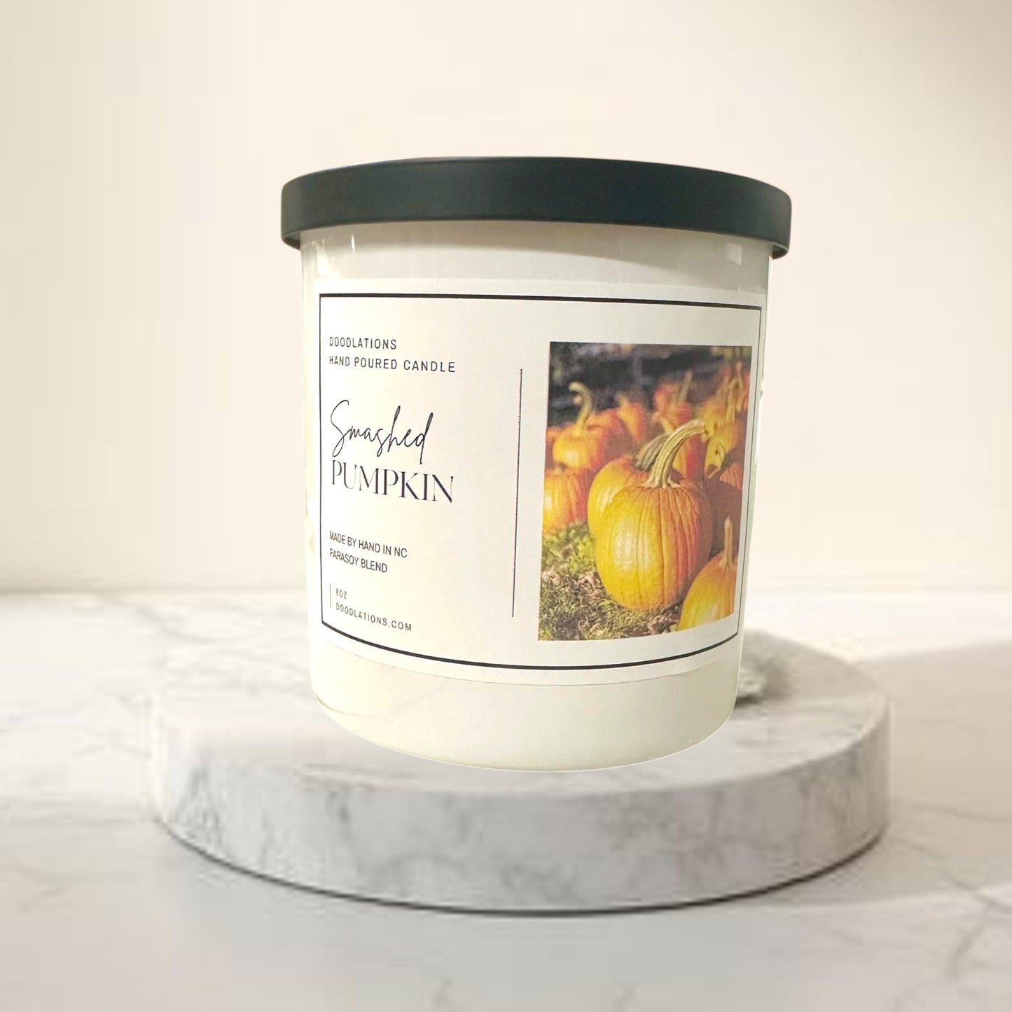 Doodlations Coffee Bar & Boutique Smashed Pumpkin hand-poured soy blend candle with a dark green lid.