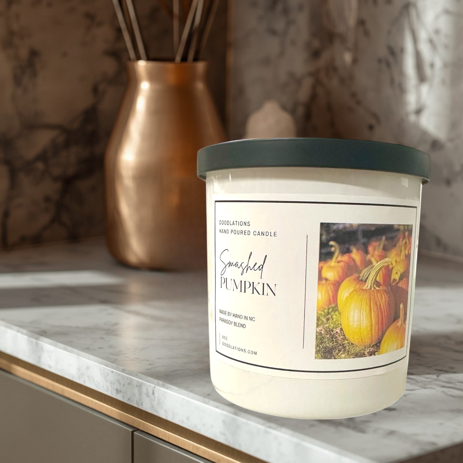Doodlations Coffee Bar & Boutique Smashed Pumpkin hand-poured soy blend candle with a dark green lid.