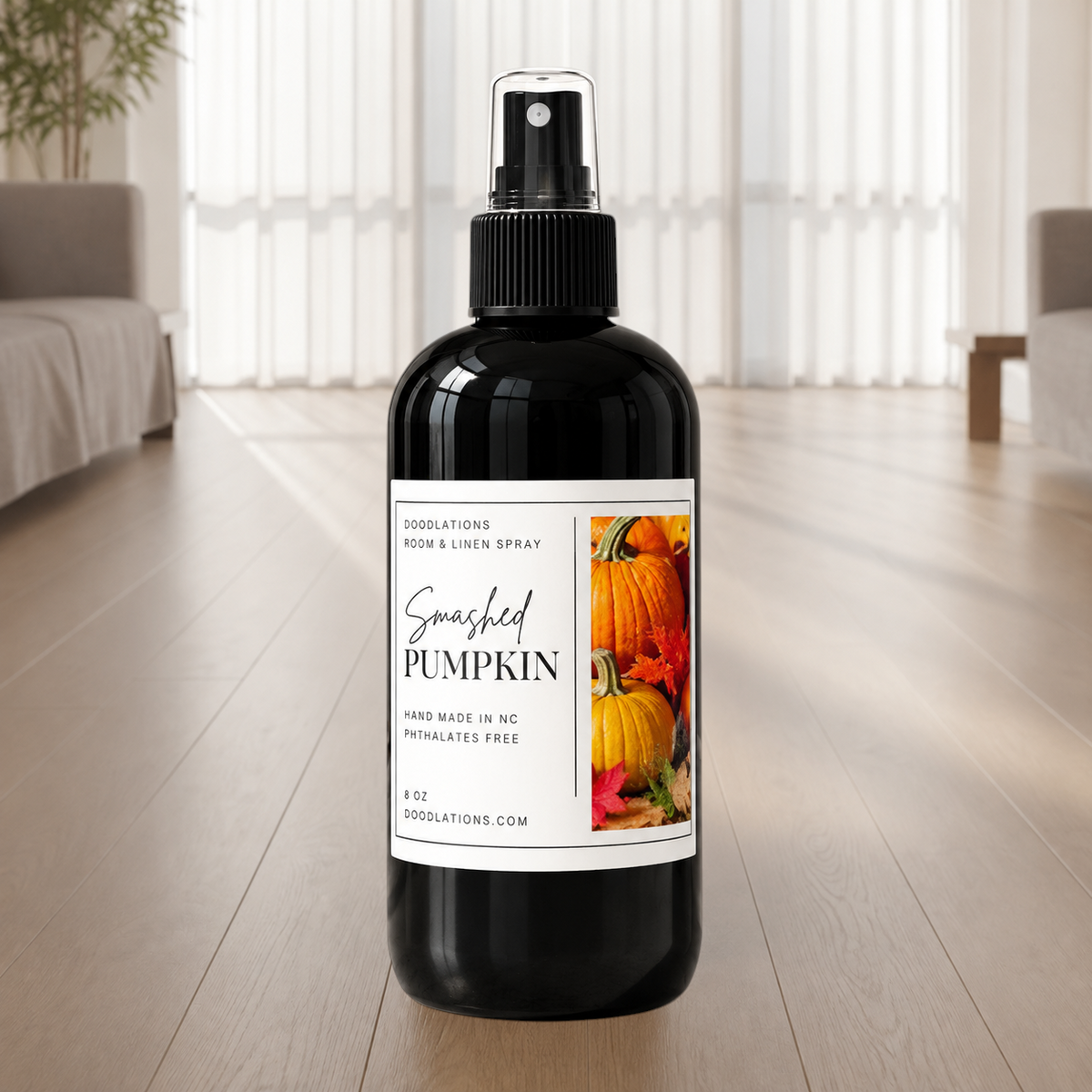 Doodlations Coffee Bar & Boutique Smashed Pumpkin room and linen spray in a black bottle with autumn pumpkin label.