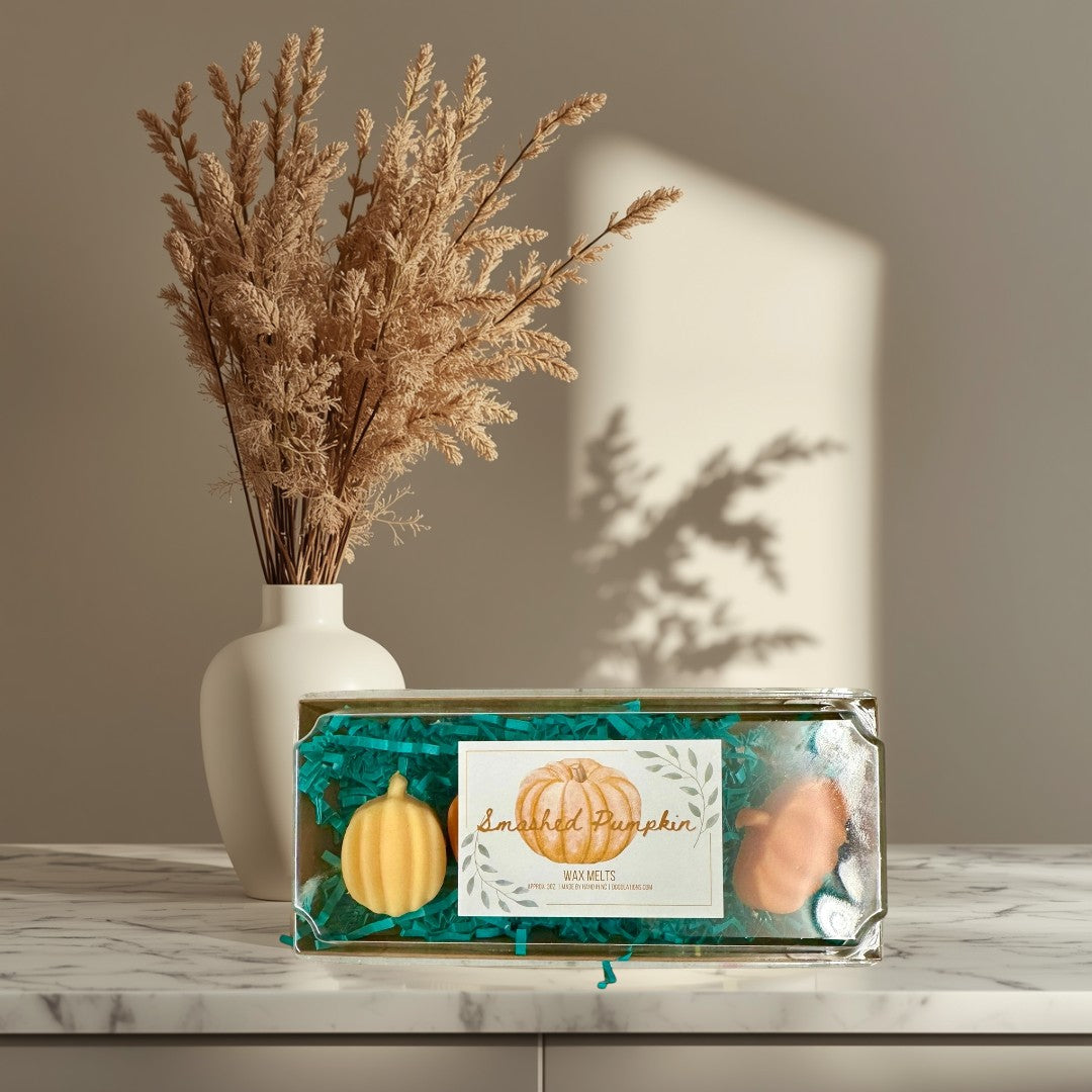 Doodlations Smashed Pumpkin wax melts in pumpkin shapes, orange and yellow, with fall fragrance.