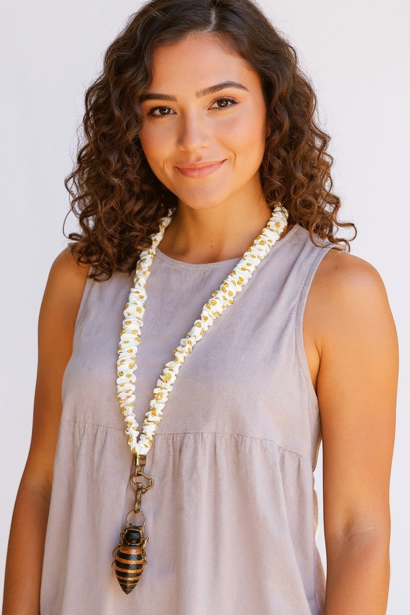 Doodlations Coffee Bar & Boutique No Worries lanyard in white luxe fabric with yellow smiley face pattern