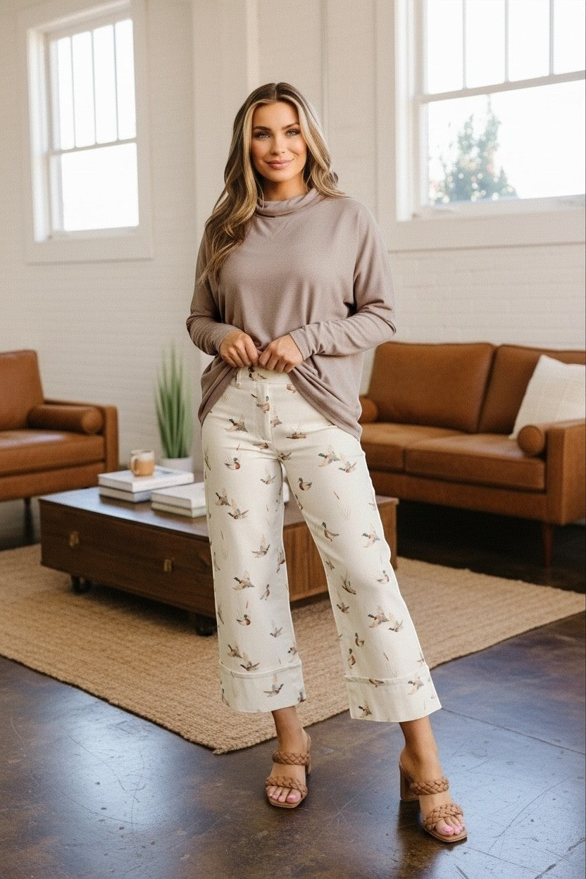 Doodlations Coffee Bar & Boutique smoke gray high neck long sleeve top worn with patterned wide-leg trousers