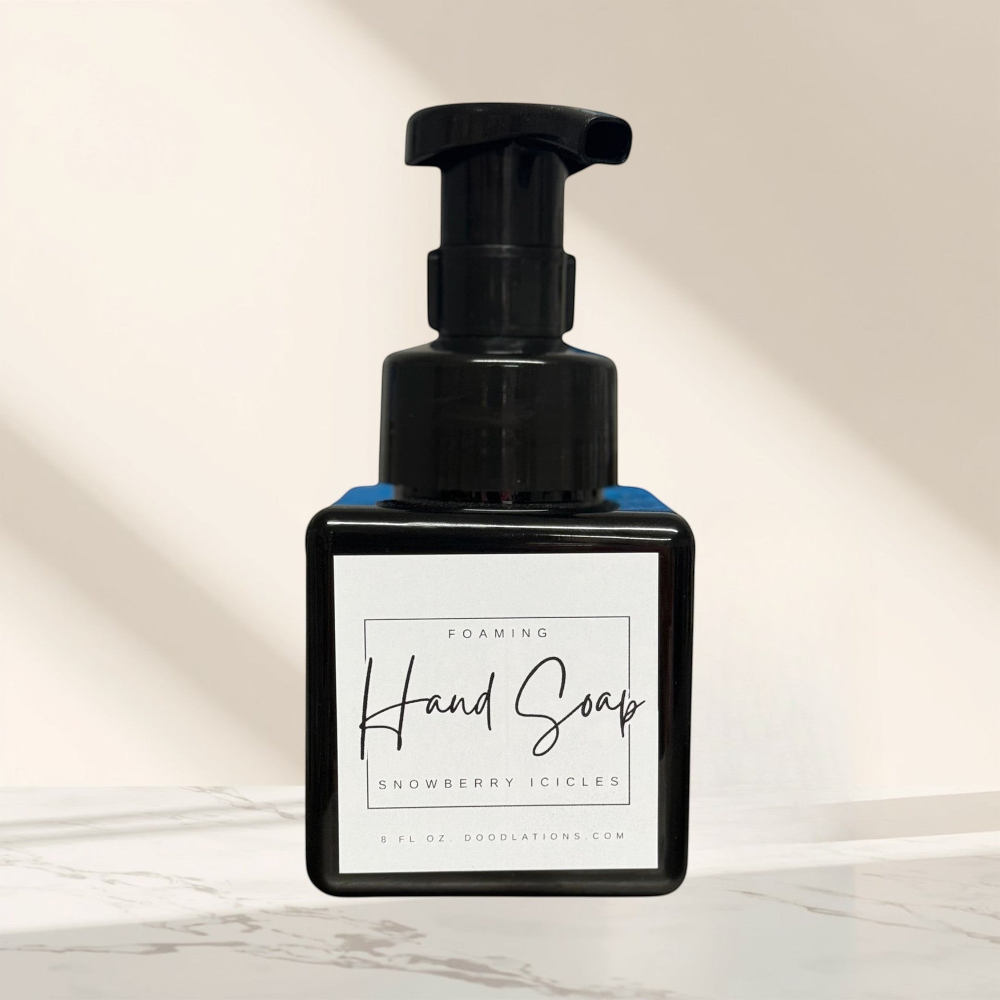 Doodlations Coffee Bar & Boutique Snowberry Icicles foaming hand soap in a black pump bottle with a white label.