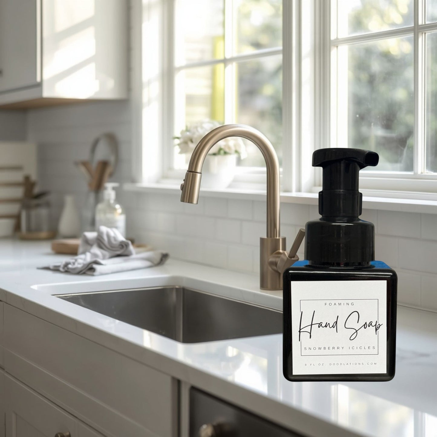 Doodlations Coffee Bar & Boutique Snowberry Icicles foaming hand soap in a black pump bottle with a white label.