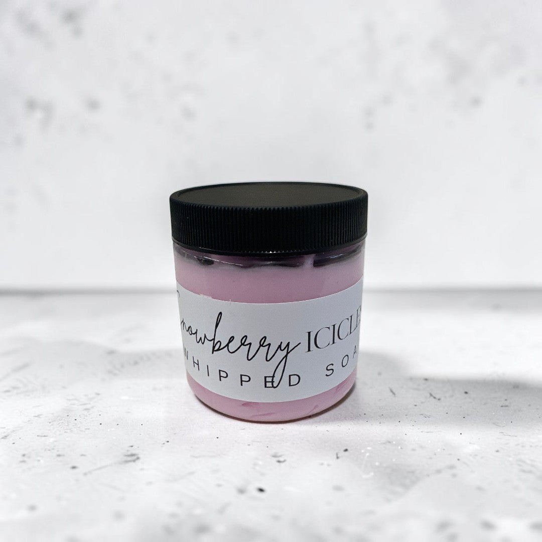 Doodlations Coffee Bar & Boutique Snowberry Icicles whipped soap in a 4 oz jar with a black lid and pink cream.