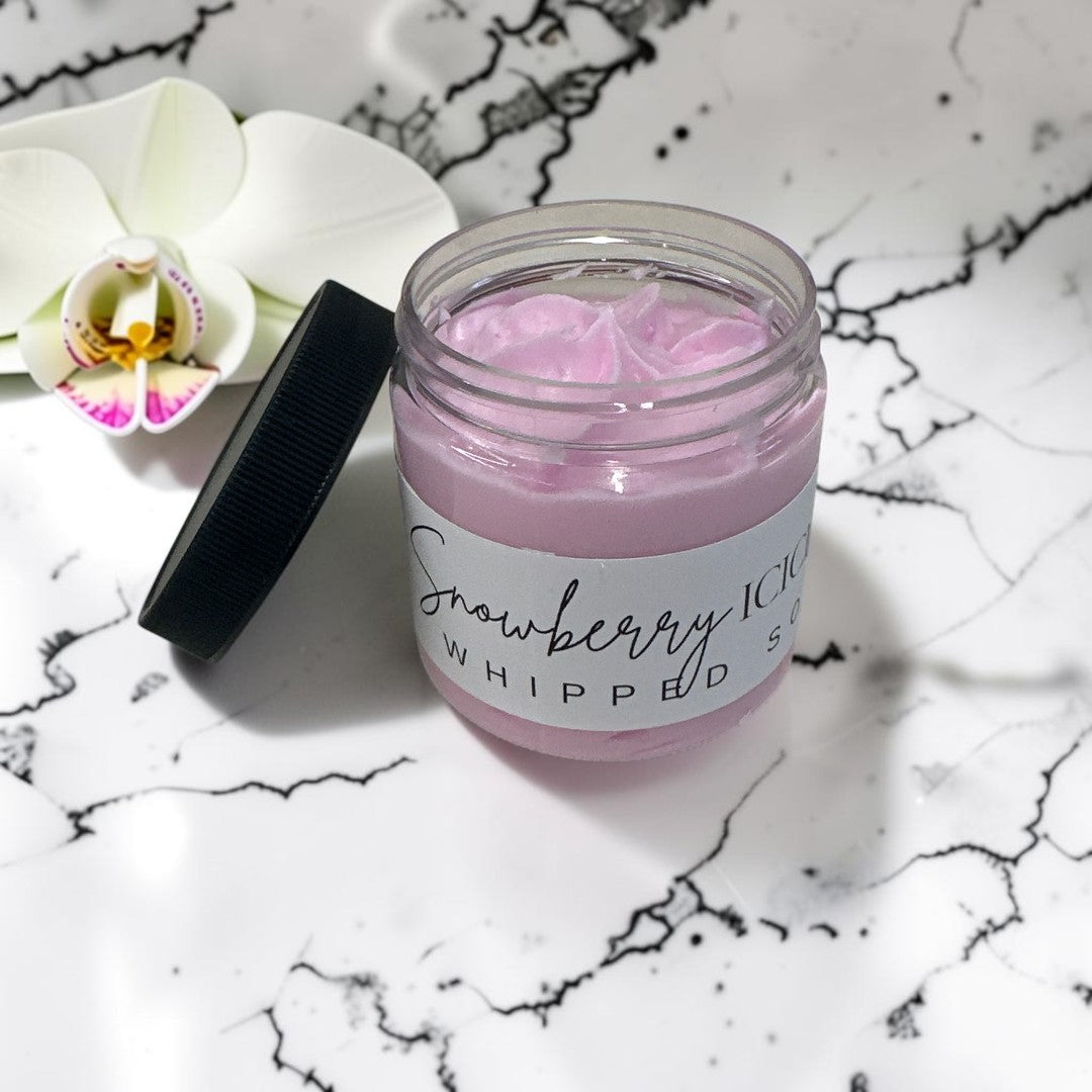Doodlations Coffee Bar & Boutique Snowberry Icicles whipped soap in a jar with a white orchid on marble background