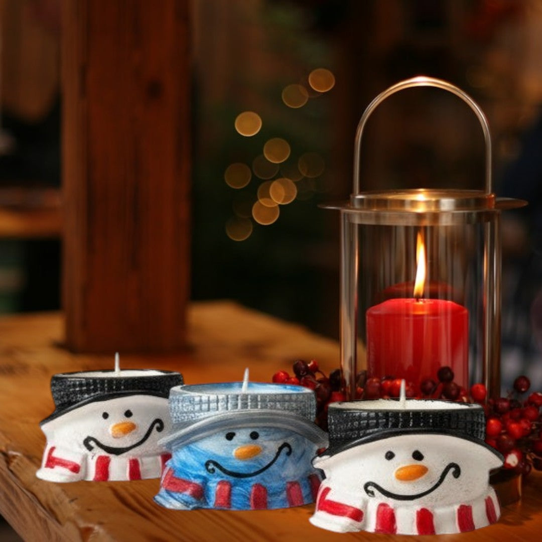 Doodlations Coffee Bar & Boutique snowman tea light holders with black hats, orange noses, and striped scarves.