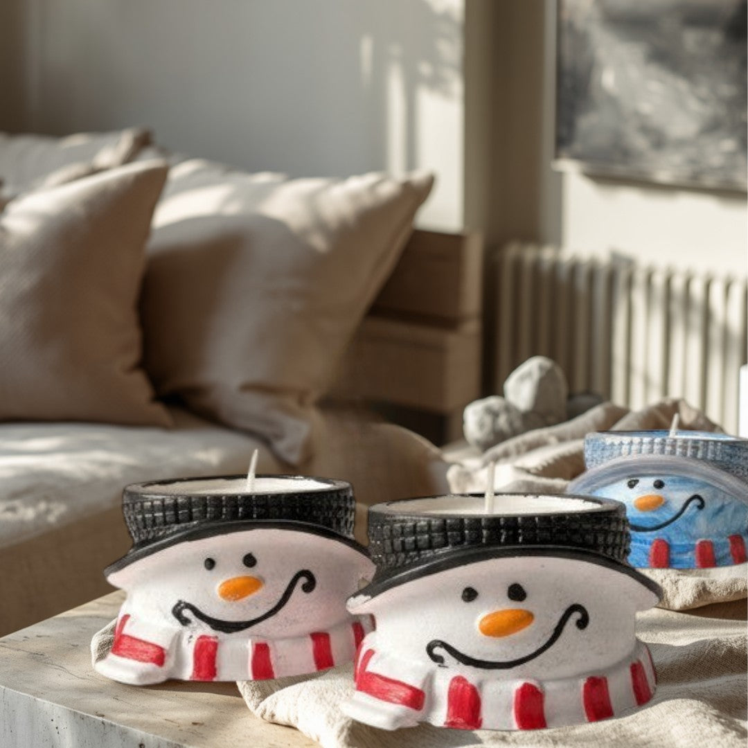 Doodlations Coffee Bar & Boutique snowman-shaped concrete tea light holder with red and white striped scarf and black hat.