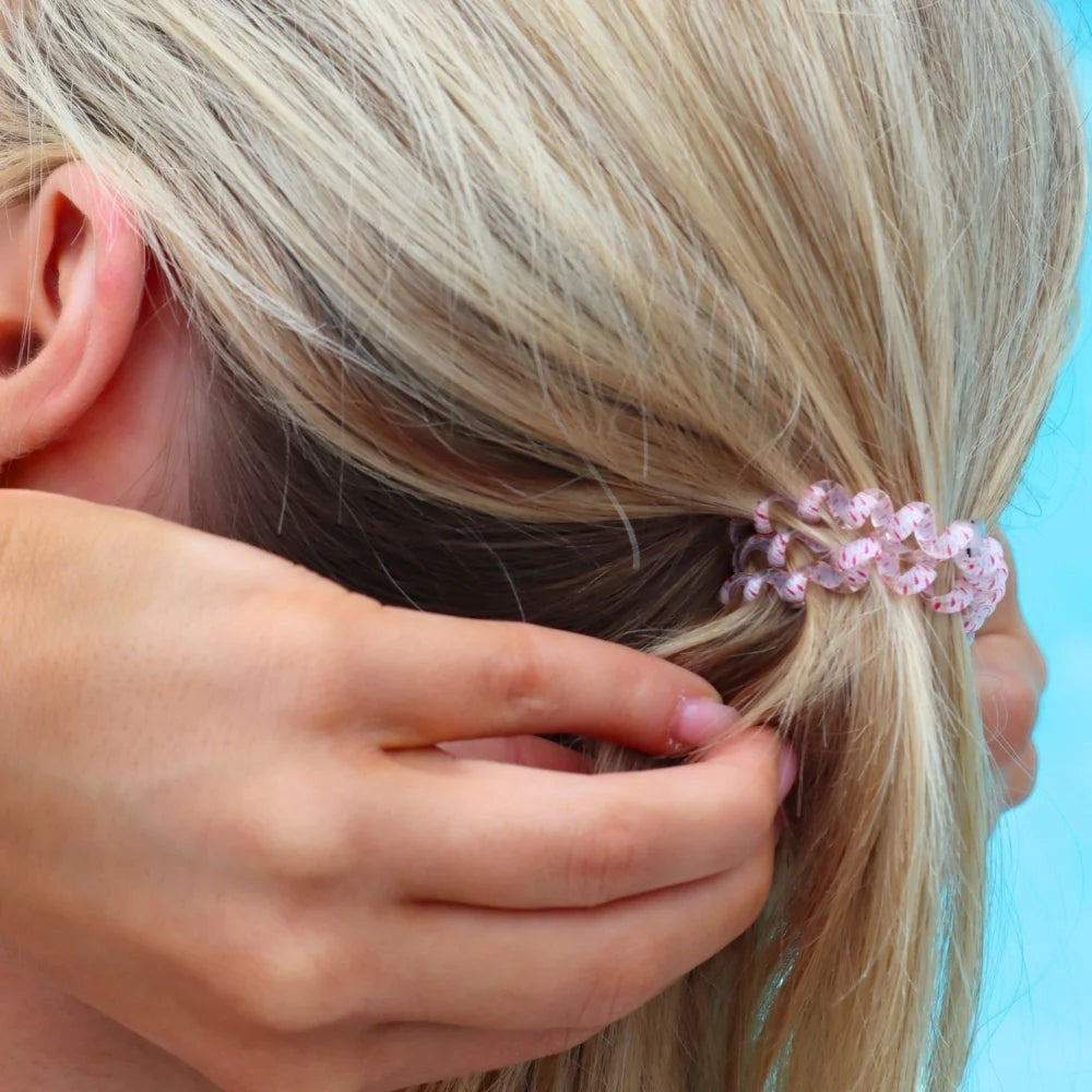 Doodlations Coffee Bar & Boutique Just Keep Swimming spiral hair tie in pink and white worn in blonde hair