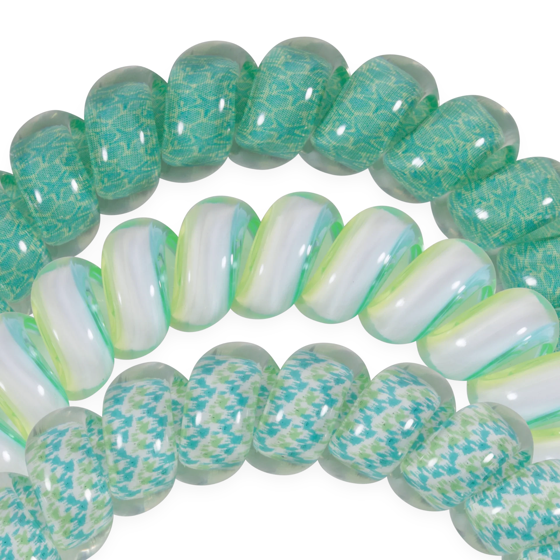 Doodlations Coffee Bar & Boutique spiral hair ties in teal and white patterns, durable and gentle on hair.