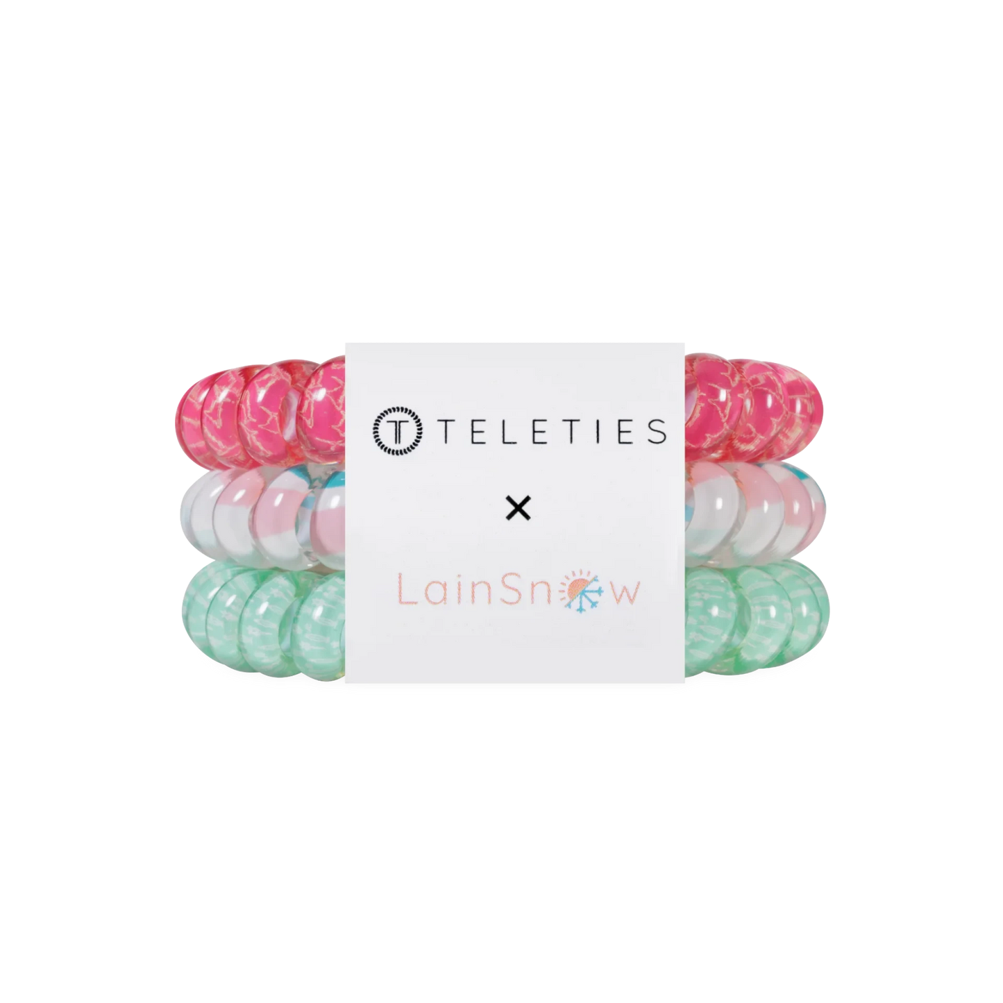 Doodlations Coffee Bar & Boutique Fin-tastic hair ties in a set of three spiral coils in pink, white, and green.