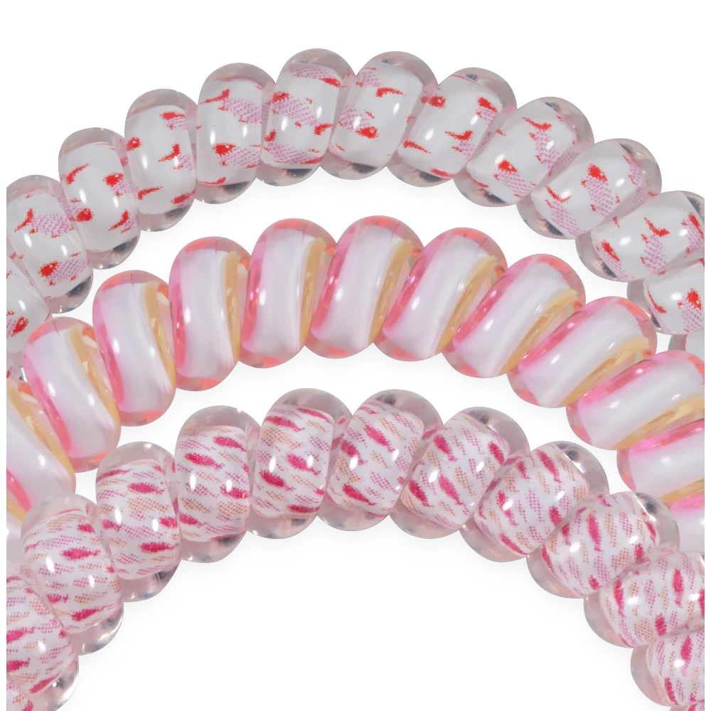Doodlations Coffee Bar & Boutique Just Keep Swimming spiral hair ties in clear, pink, and white patterned designs.