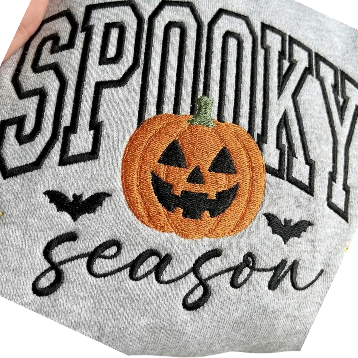 Doodlations Coffee Bar & Boutique grey sweatshirt with embroidered Spooky Season text, pumpkin, and bat designs.