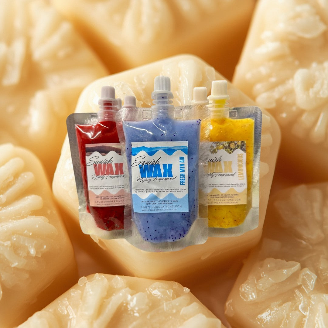 Doodlations Coffee Bar & Boutique Squish Wax Melts in red, blue, and yellow pouches with glitter. Highly fragranced.