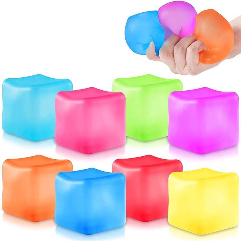 Doodlations Coffee Bar & Boutique Squishy Cubes in bright blue, pink, green, purple, orange, red, and yellow. Soft, pliable material for stress relief and sensory play.