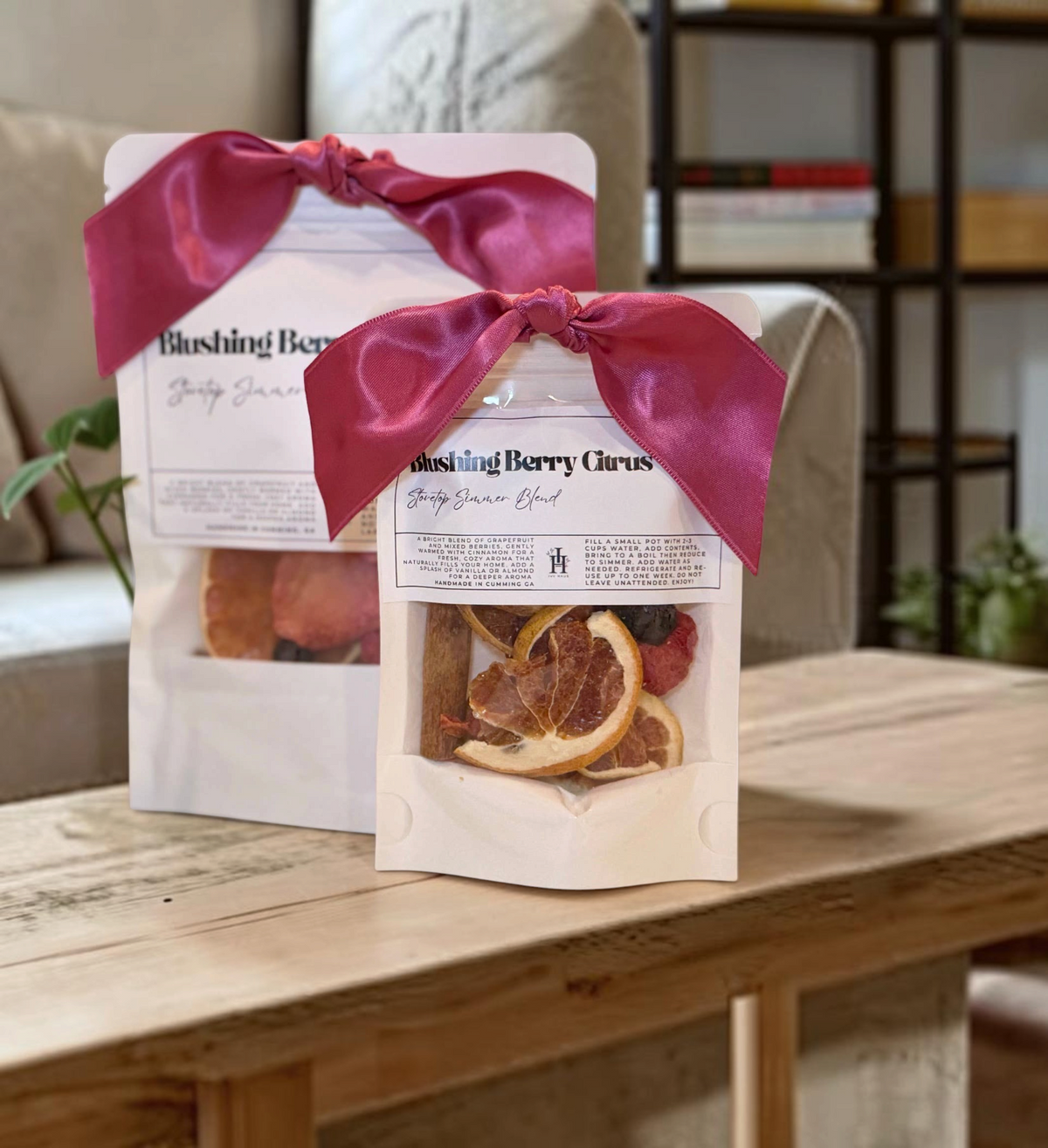 Doodlations Coffee Bar & Boutique Blushing Berry Citrus stovetop simmer blend in white pouches with pink ribbon bows.