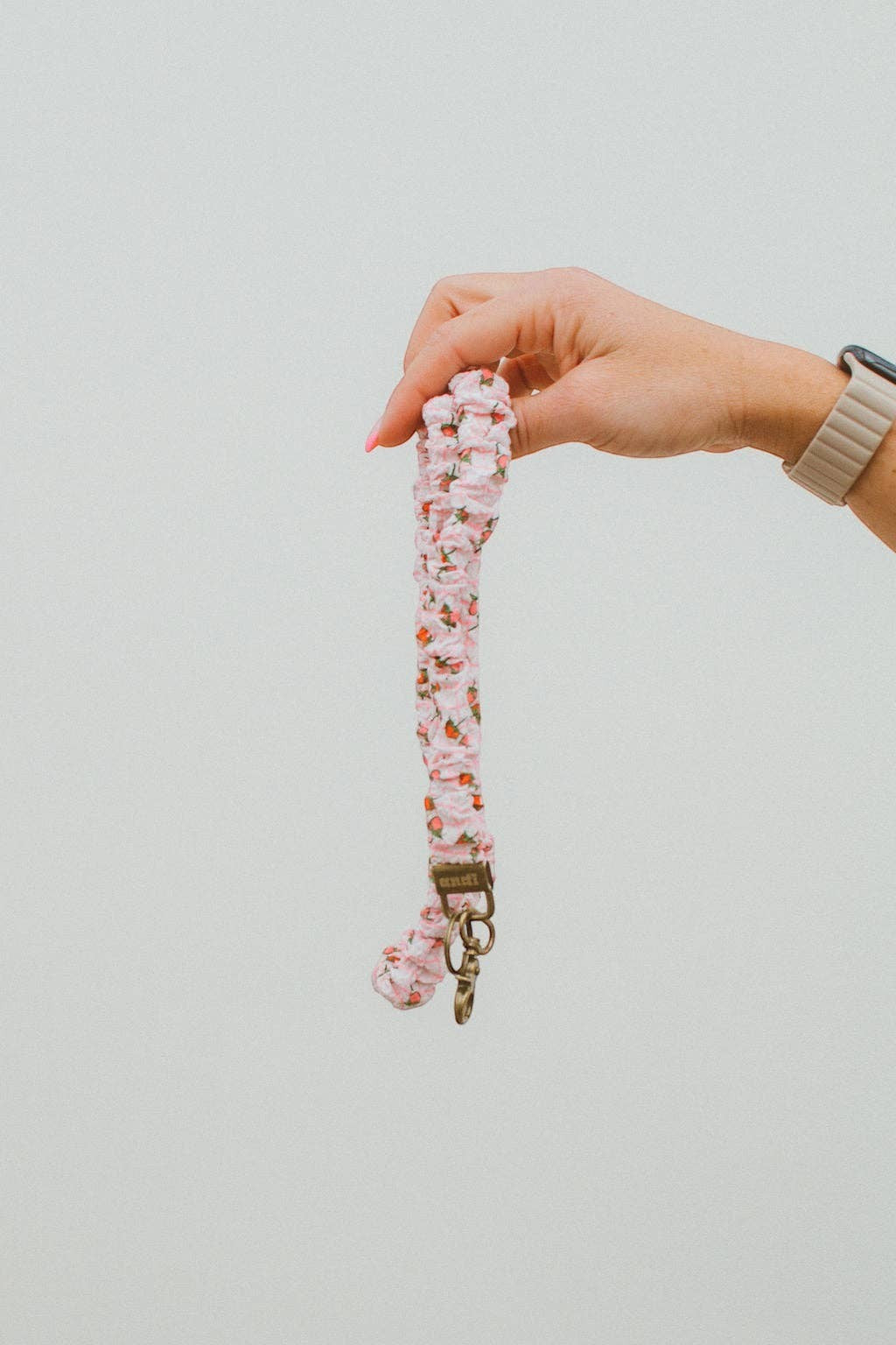 Doodlations Coffee Bar & Boutique strawberry print lanyard in pink and cream gingham textured fabric with gold clasp