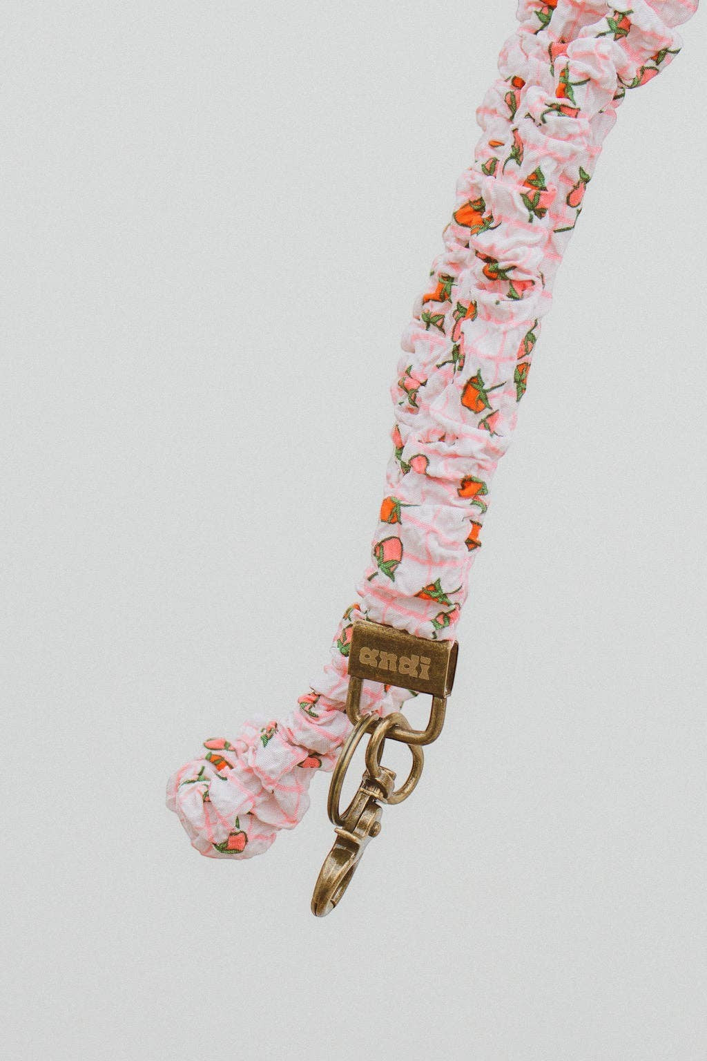 Doodlations Coffee Bar & Boutique strawberry print lanyard in pink and cream gingham textured fabric with gold clasp