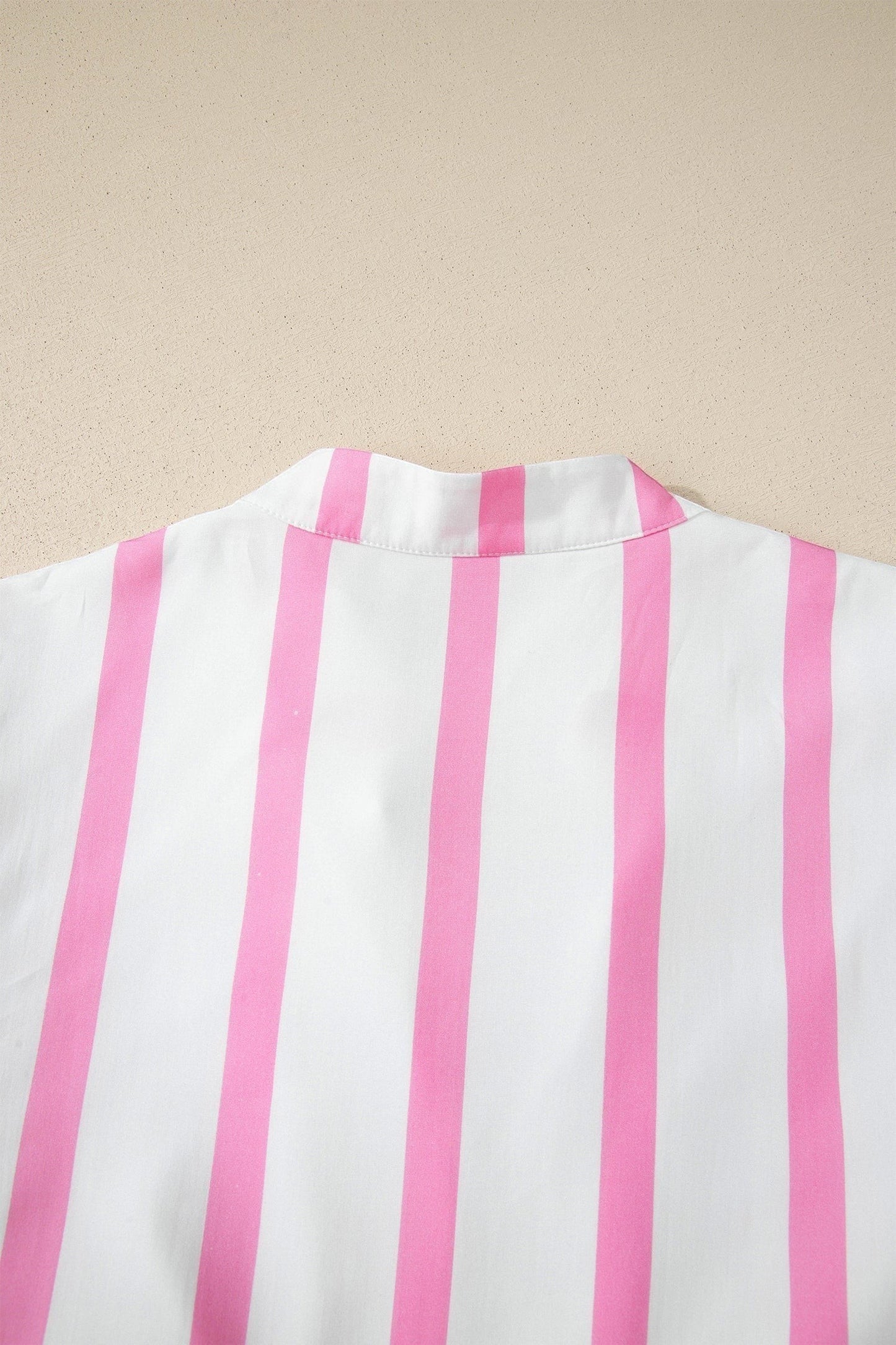 Doodlations Coffee Bar & Boutique white and pink striped v-neck tunic with puffed sleeves and scalloped trim.