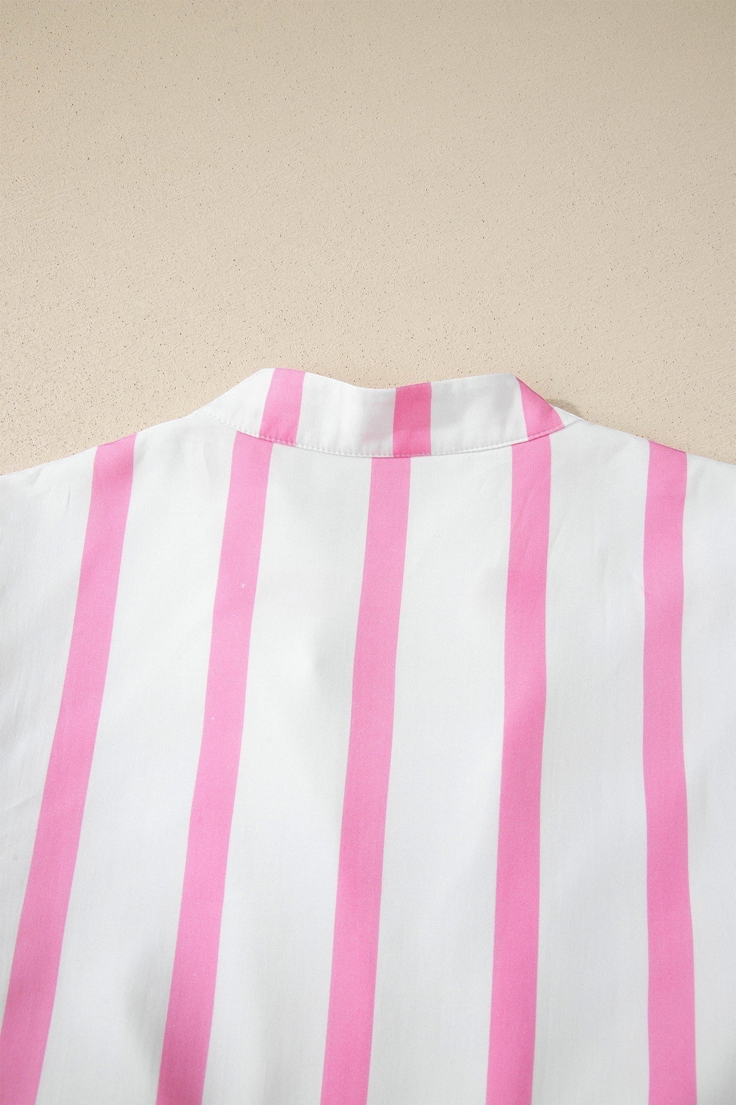 Doodlations Coffee Bar & Boutique white and pink striped v-neck tunic with puffed sleeves and scalloped trim.