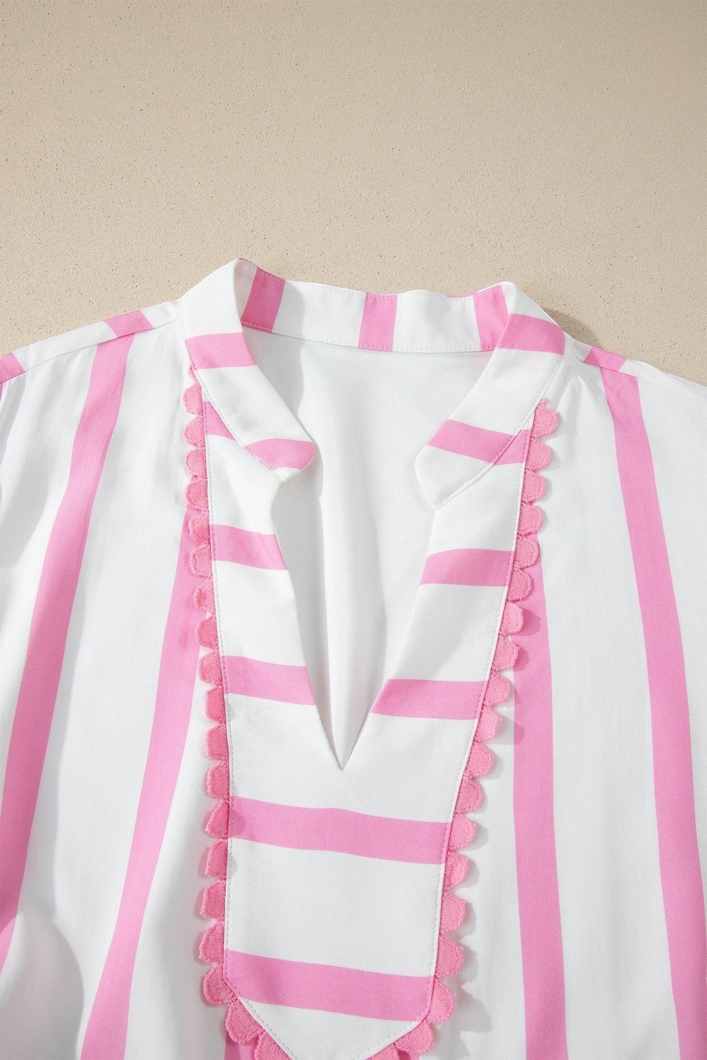Doodlations Coffee Bar & Boutique white and pink striped tunic with V-neck and scalloped trim detail.