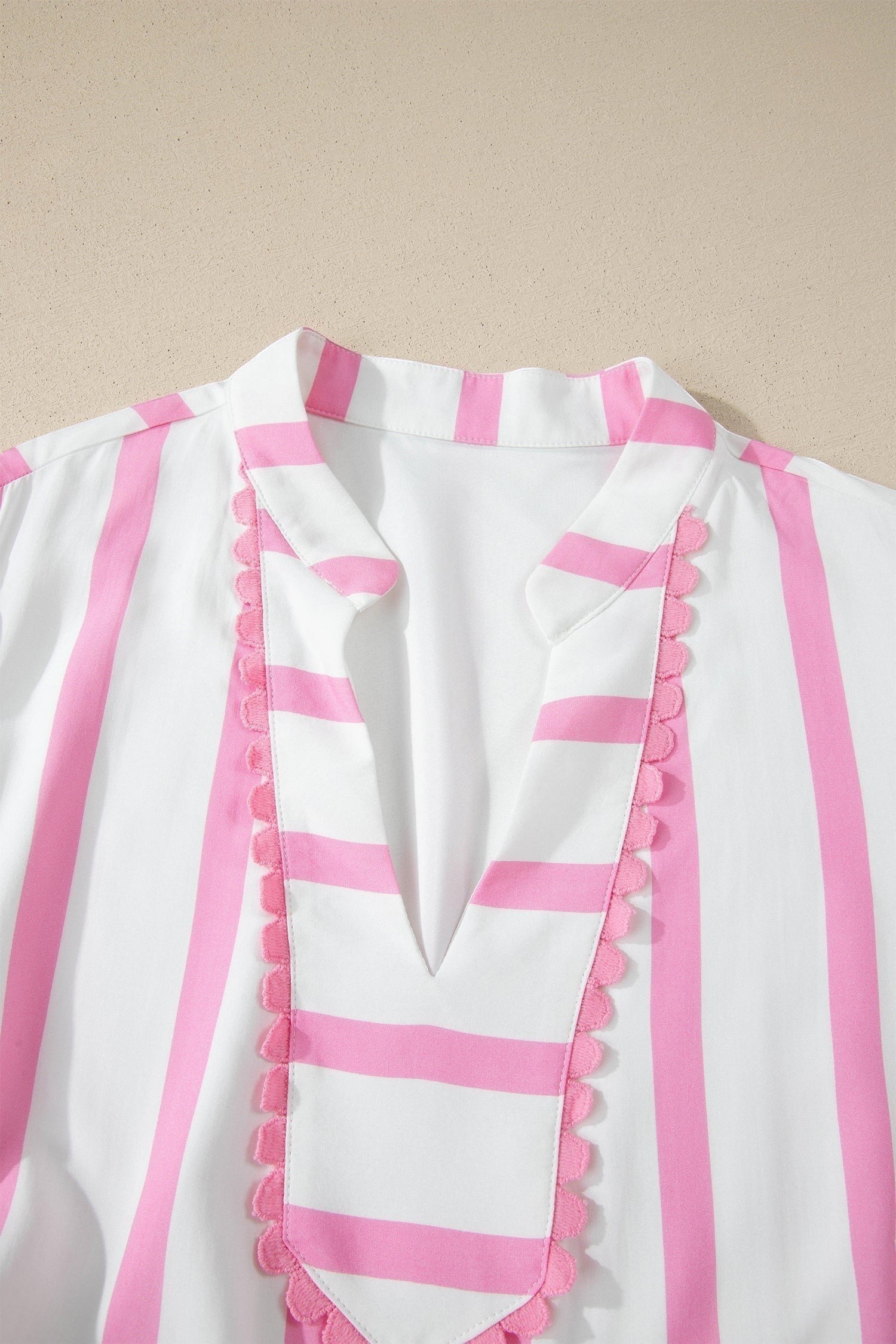 Doodlations Coffee Bar & Boutique white and pink striped tunic with V-neck and scalloped trim detail.