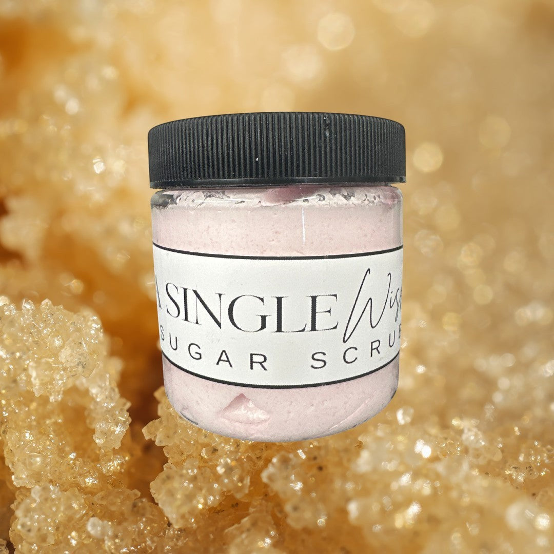 Doodlations Coffee Bar & Boutique A Single Wish sugar scrub in a clear jar with a black lid. Pink scrub.