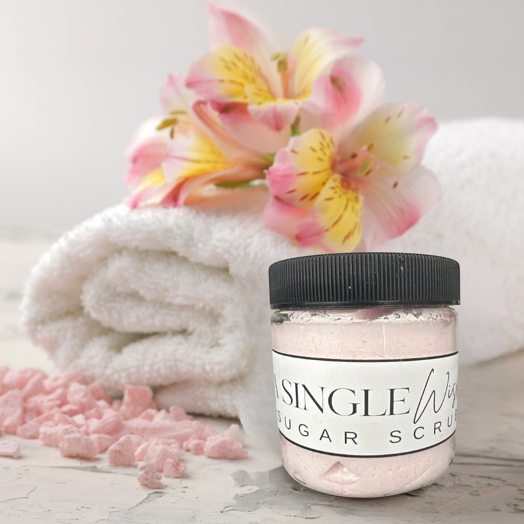 Doodlations Coffee Bar & Boutique A Single Wish sugar scrub in a clear jar with a black lid, light pink color.