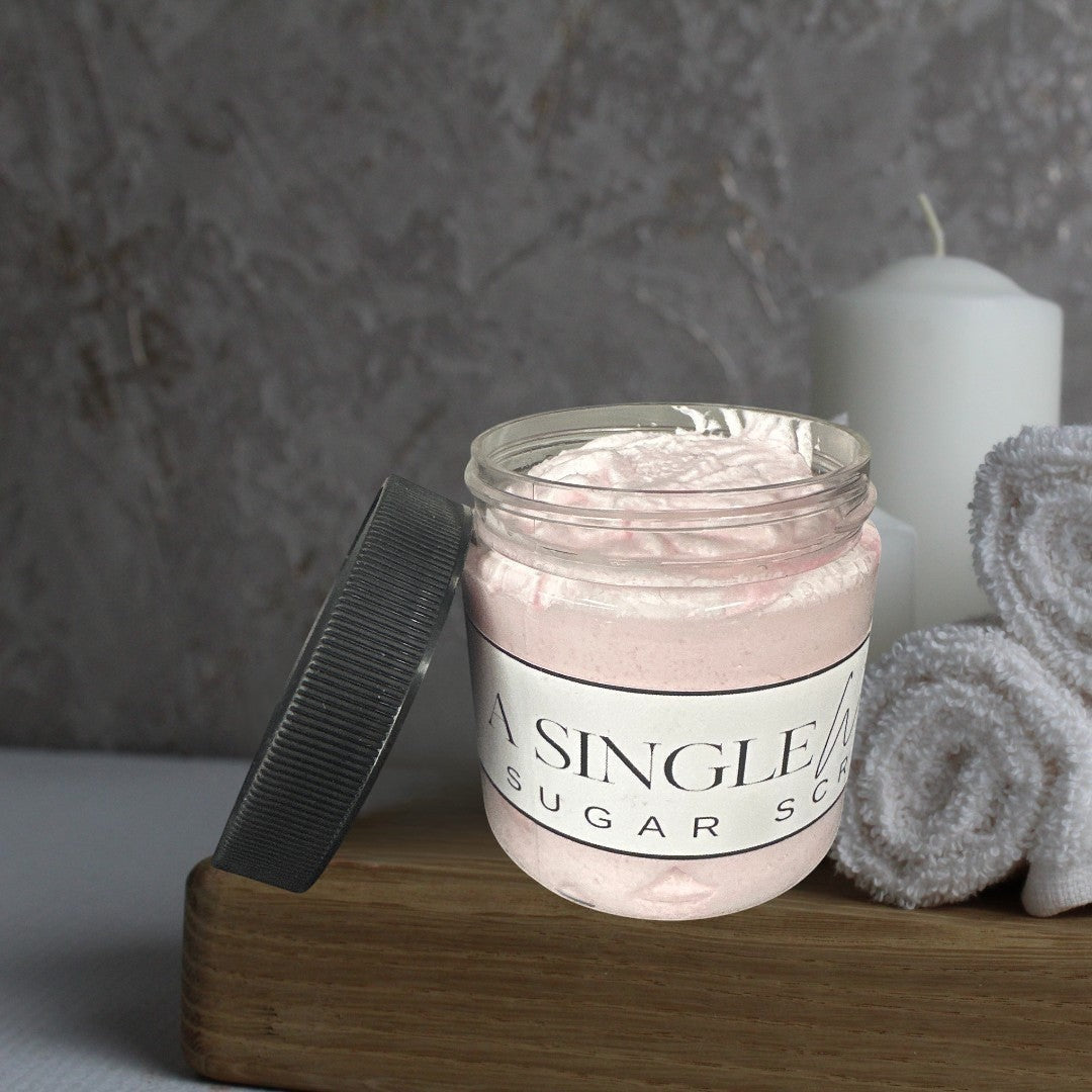 Doodlations Coffee Bar & Boutique A Single Wish pink sugar scrub in a clear jar with a black lid.