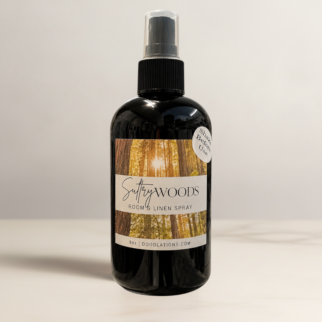 Doodlations Coffee Bar & Boutique Sultry Woods room and linen spray in a black glass bottle with a forest label