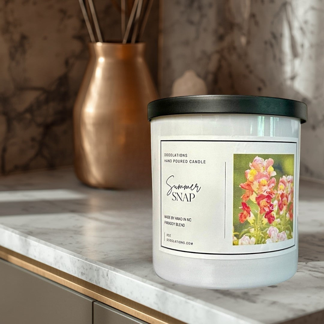 Doodlations Coffee Bar & Boutique Summer Snap hand-poured parasoy blend candle with floral-fruity scent.