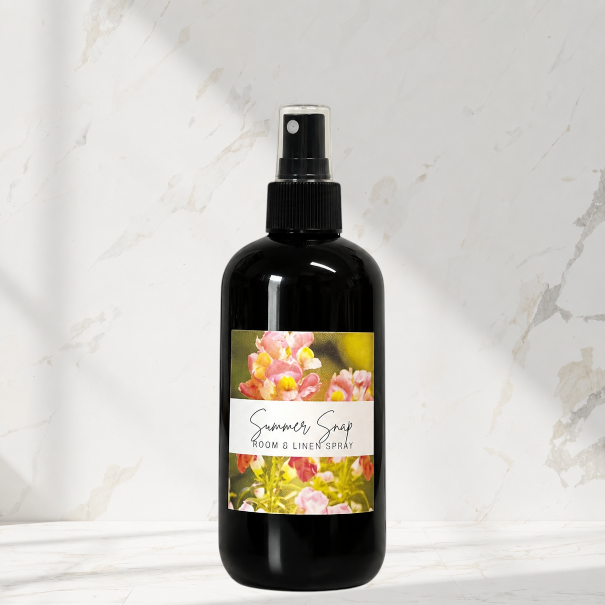 Doodlations Coffee Bar & Boutique Summer Snap room and linen spray in a black bottle with a floral label