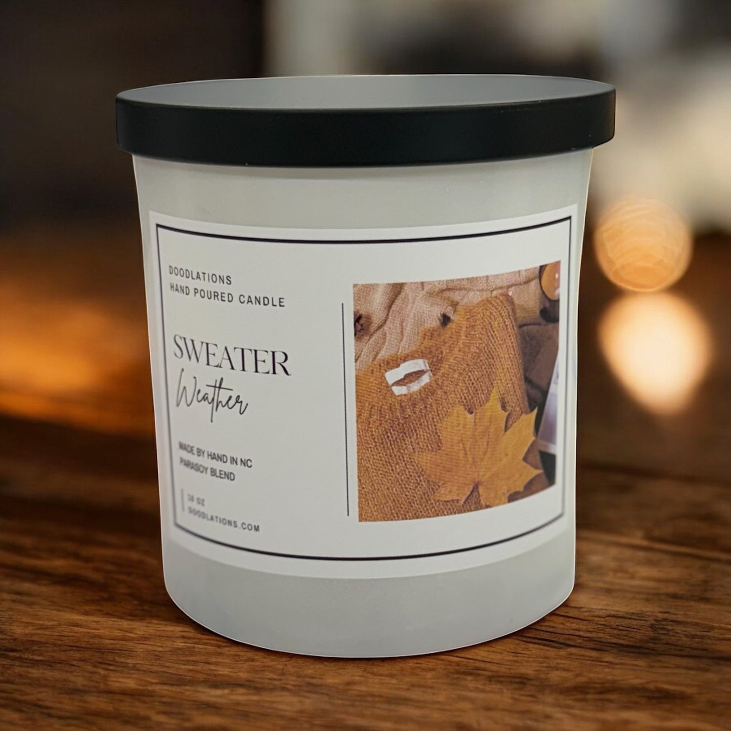 Doodlations Coffee Bar & Boutique Sweater Weather hand-poured soy blend candle with autumn leaf imagery.