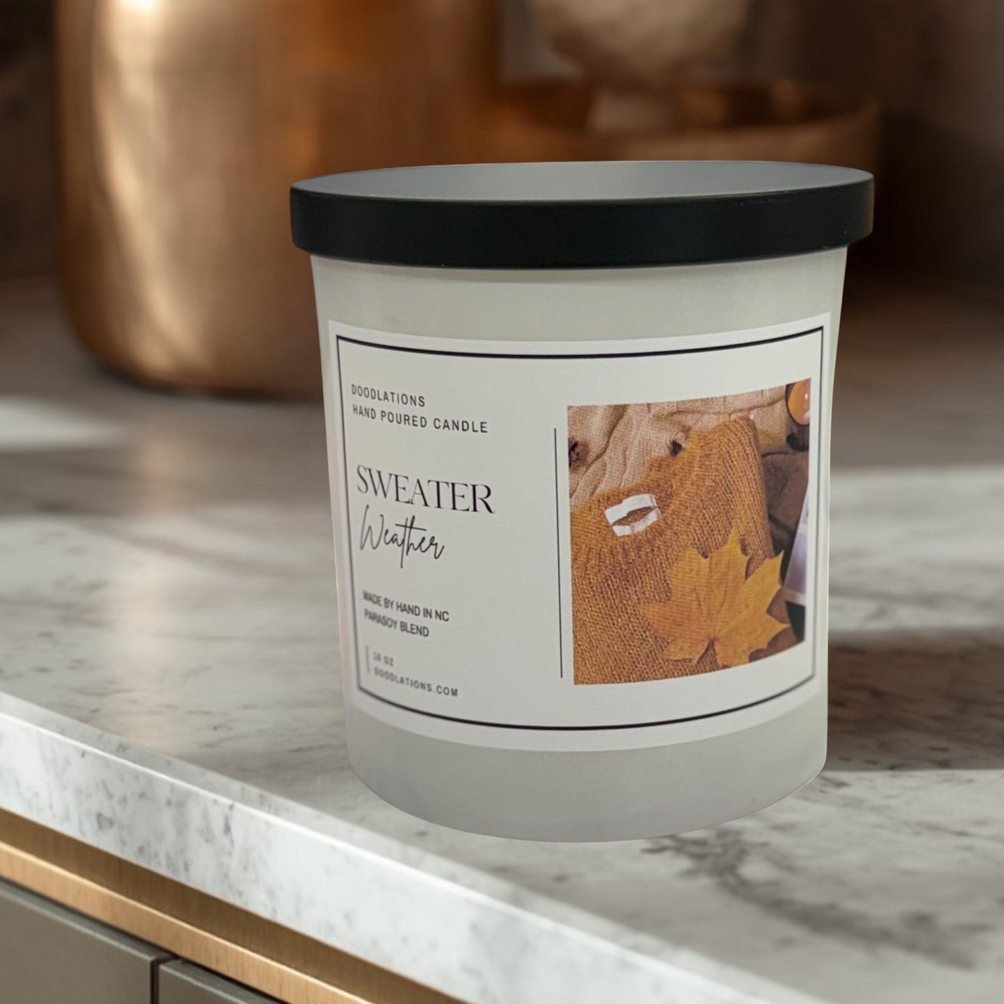 Doodlations Coffee Bar & Boutique Sweater Weather hand-poured soy blend candle with autumn leaf imagery.