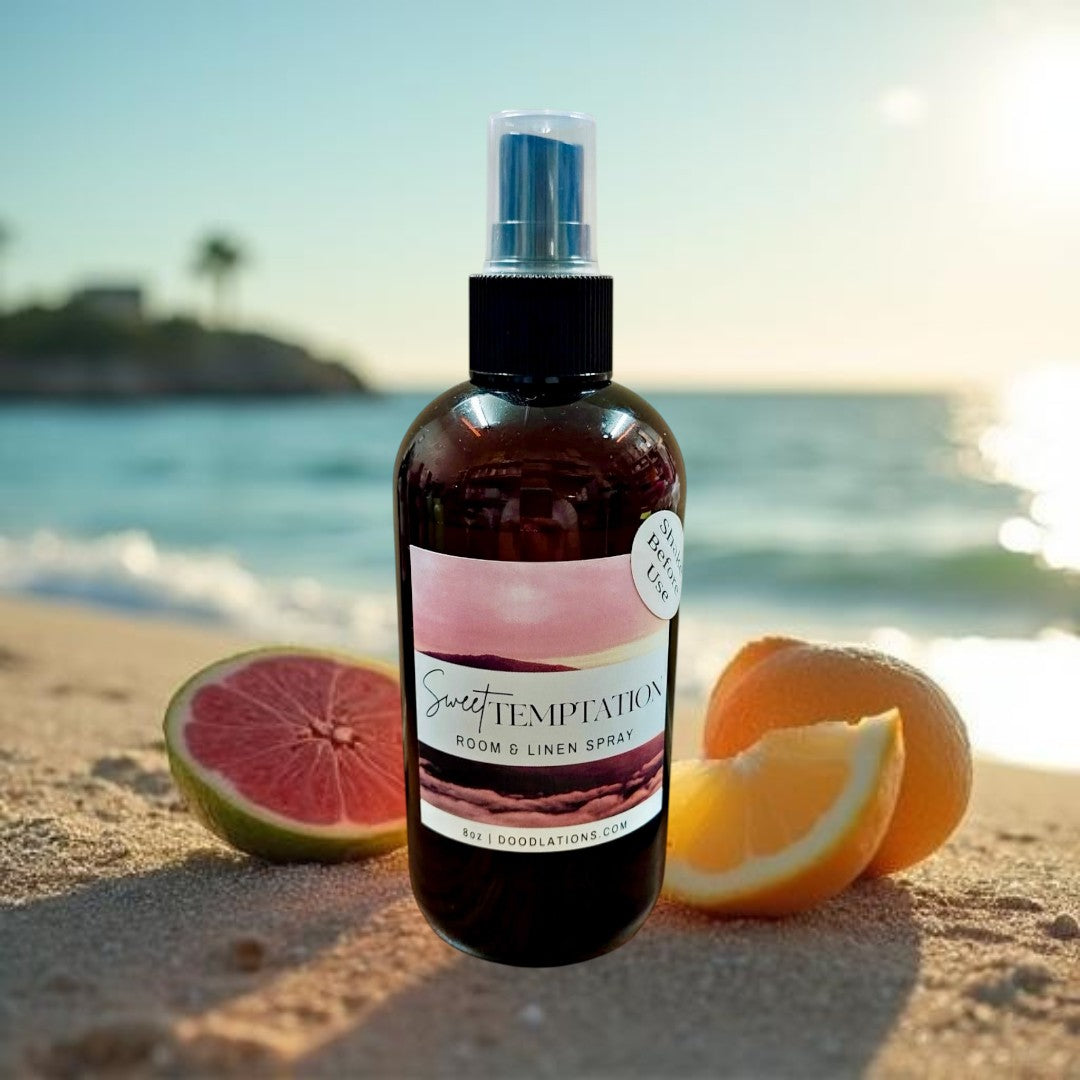 Doodlations Coffee Bar & Boutique Sweet Temptation room and linen spray in amber bottle with pink label. Tropical scent.