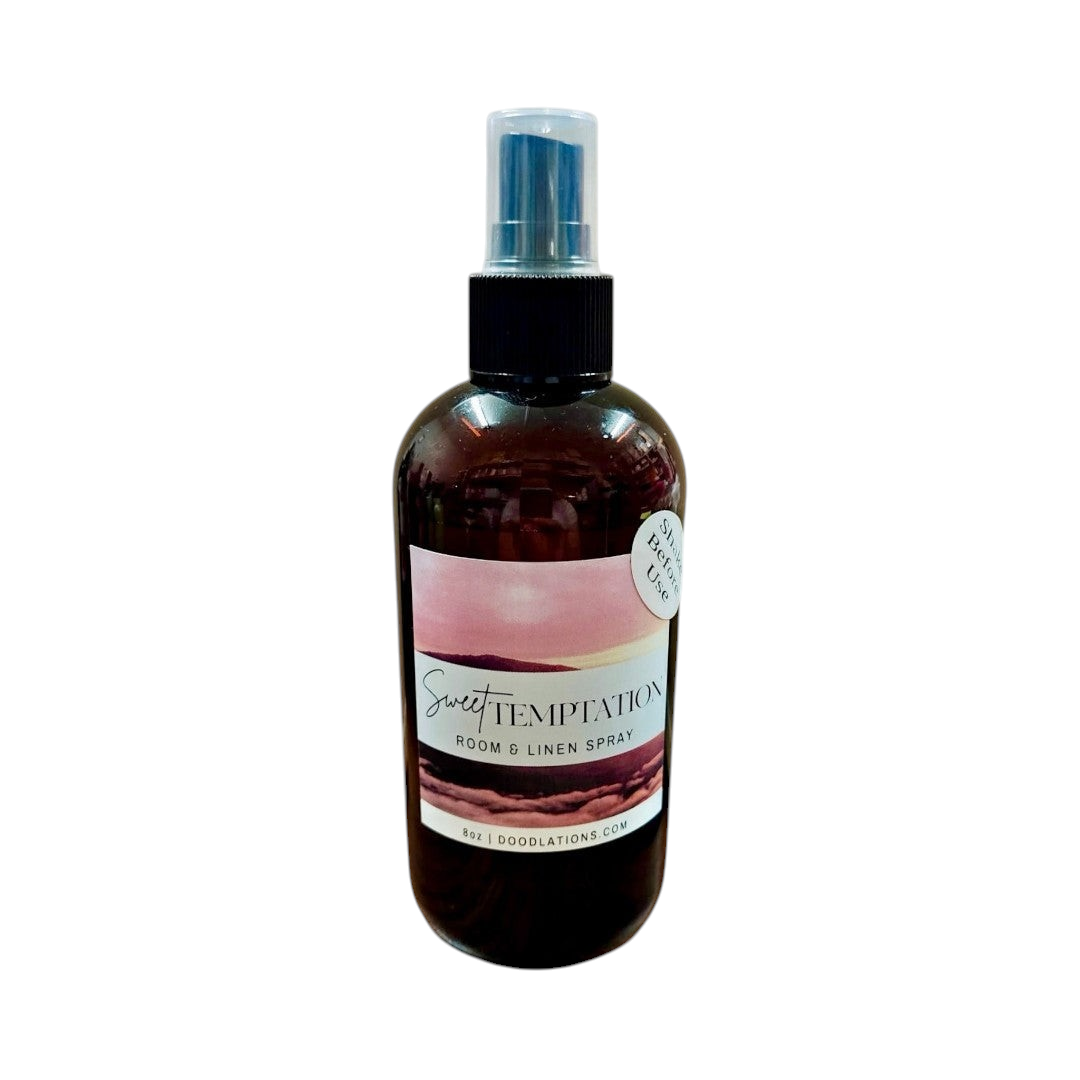 Doodlations Coffee Bar & Boutique Sweet Temptation room and linen spray in an amber bottle with a tropical label.