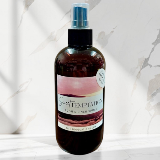 Doodlations Coffee Bar & Boutique Sweet Temptation room and linen spray in a dark amber bottle with a tropical label.