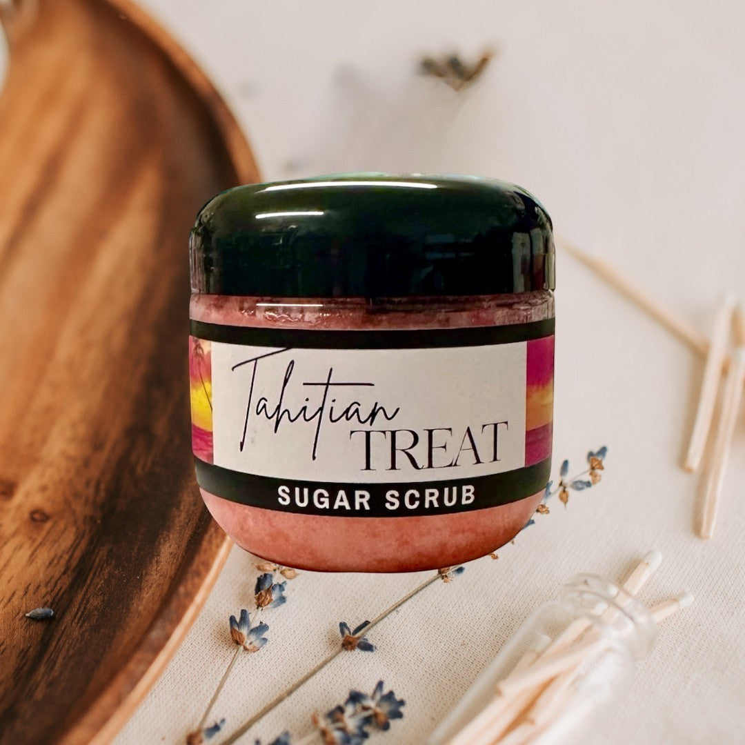 Doodlations Coffee Bar & Boutique Tahitian Treat Sugar Scrub, pink exfoliating body scrub in a clear jar with a black lid.