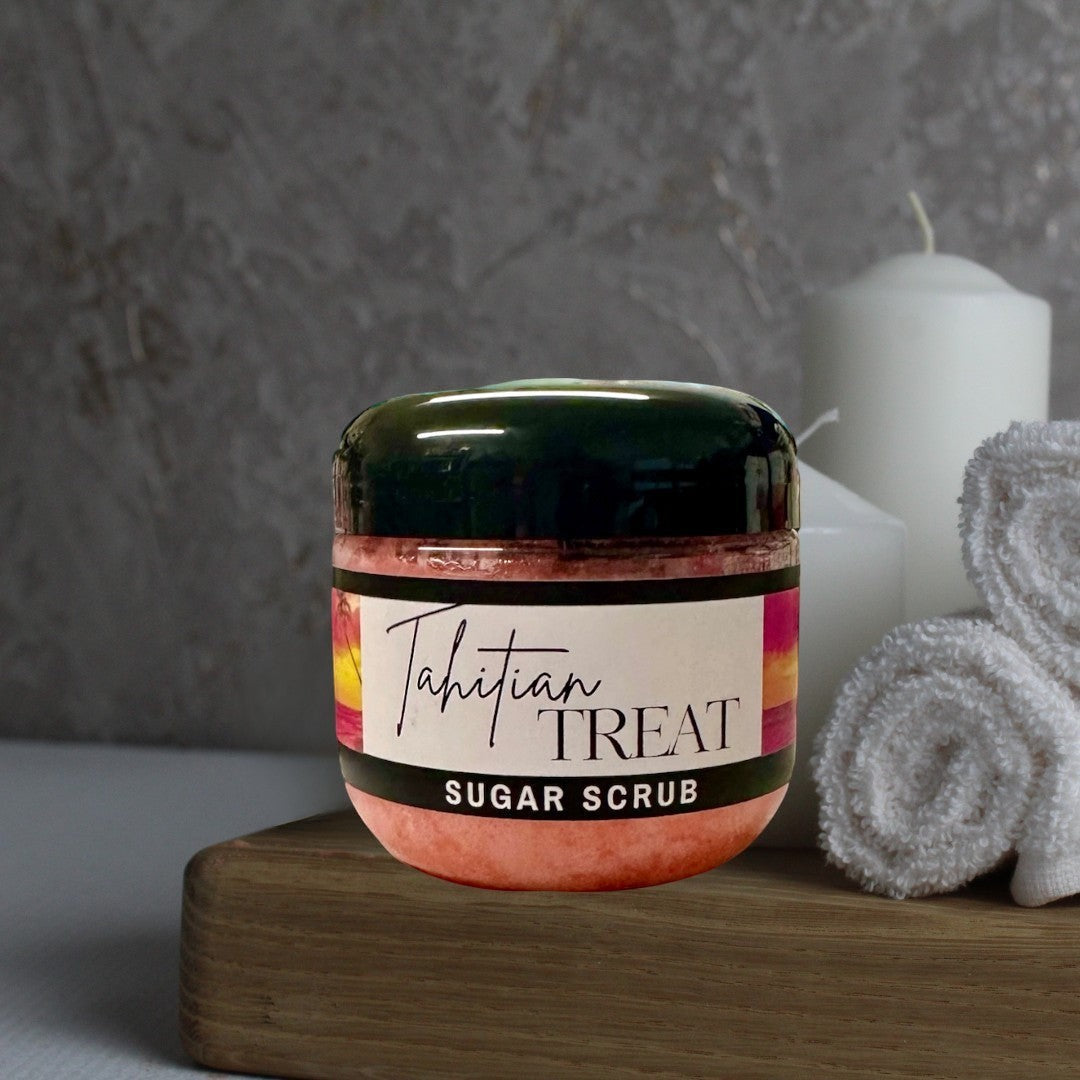Doodlations Coffee Bar & Boutique Tahitian Treat Sugar Scrub, a pink exfoliating body scrub in a clear jar with a black lid.