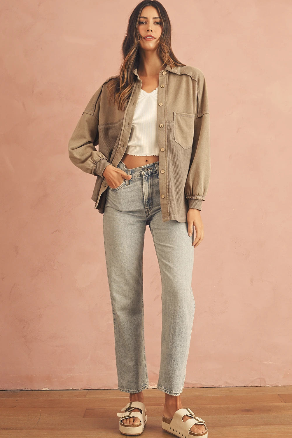 Model wearing a Doodlations Coffee Bar & Boutique tan mineral wash patchwork shacket with light wash jeans.