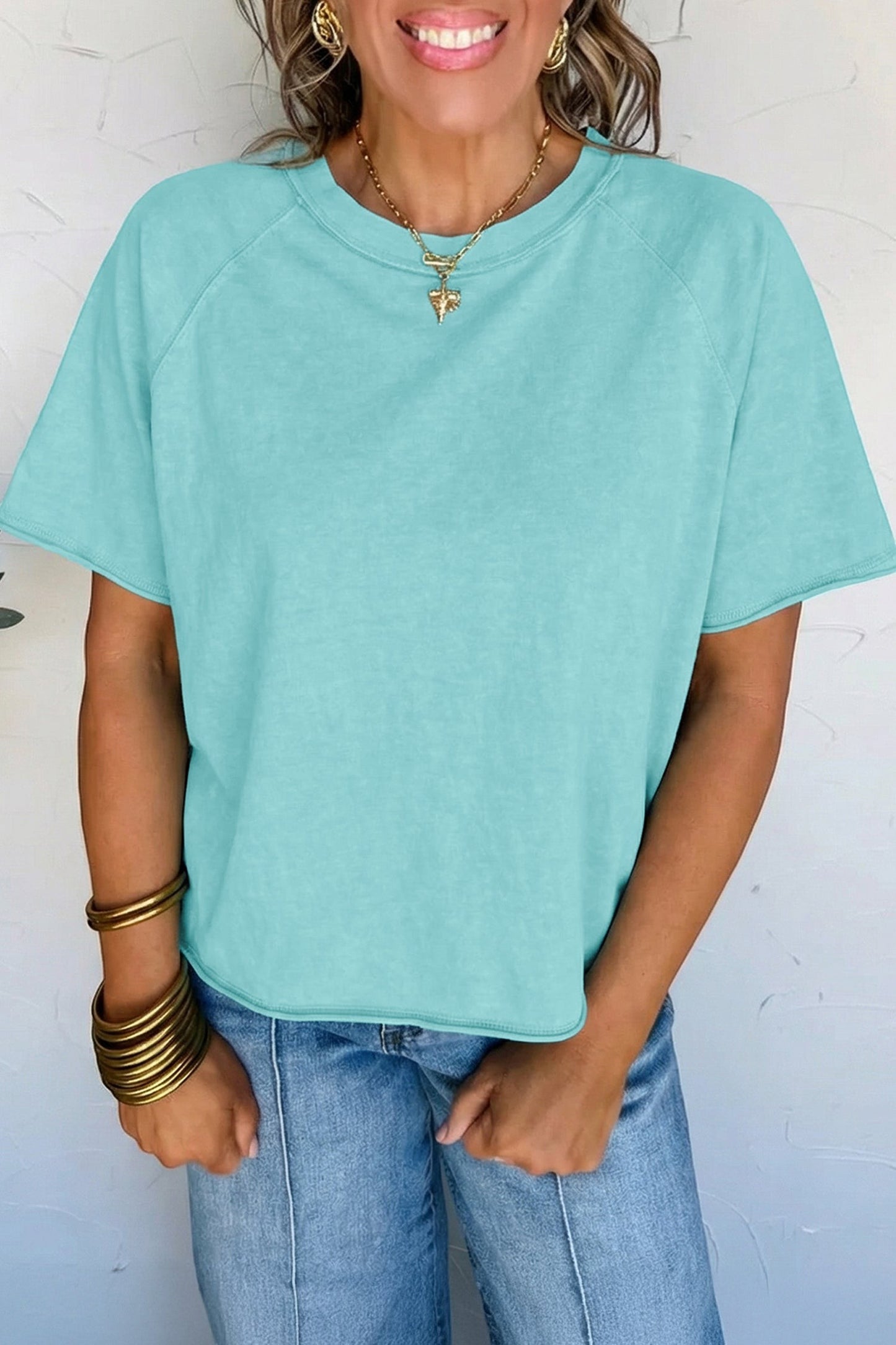 Doodlations Coffee Bar & Boutique teal mineral wash cotton blend tee with raw hem and sleeves.