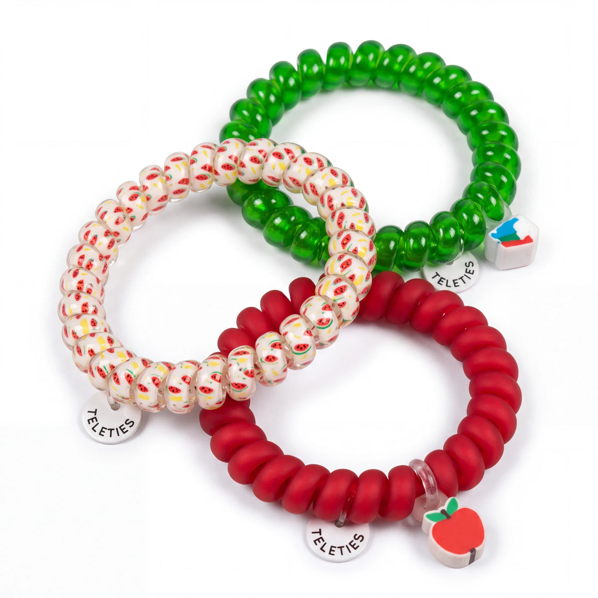 Doodlations Coffee Bar & Boutique Teleties hair ties in red, green, and watermelon print with apple and book charms.