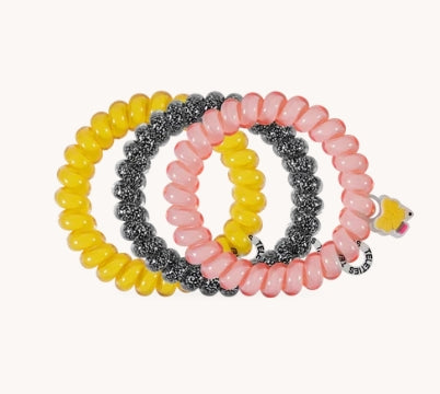 Doodlations Coffee Bar & Boutique Teleties Study Buddy hair ties in yellow, pink, and glittery black coil design.