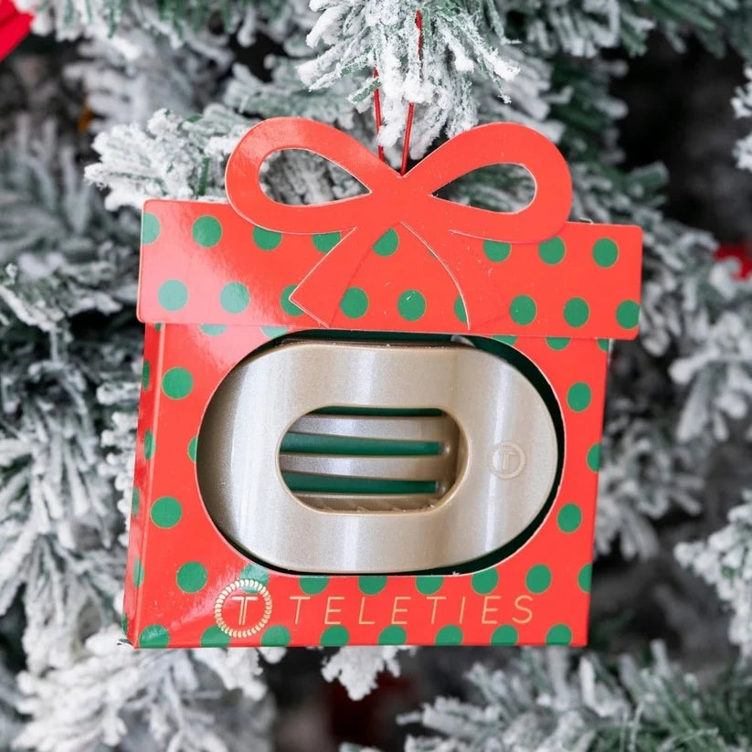 Doodlations Coffee Bar & Boutique TELETIES flat round hair clip inside a festive polka dot gift ornament on a tree.