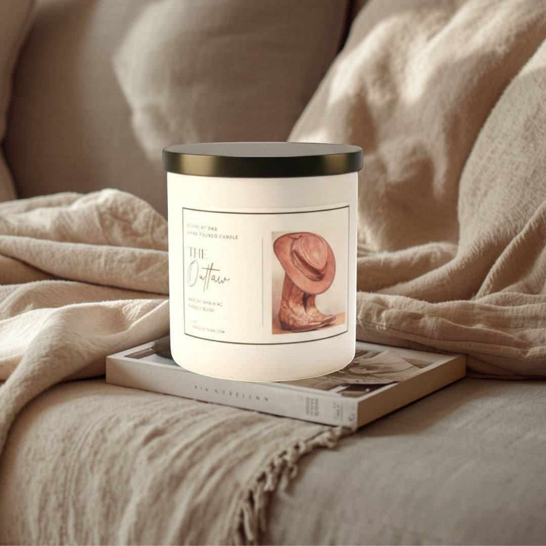 Doodlations Coffee Bar & Boutique The Outlaw luxury soy blend candle with a cowboy boot and hat illustration. Masculine scent.