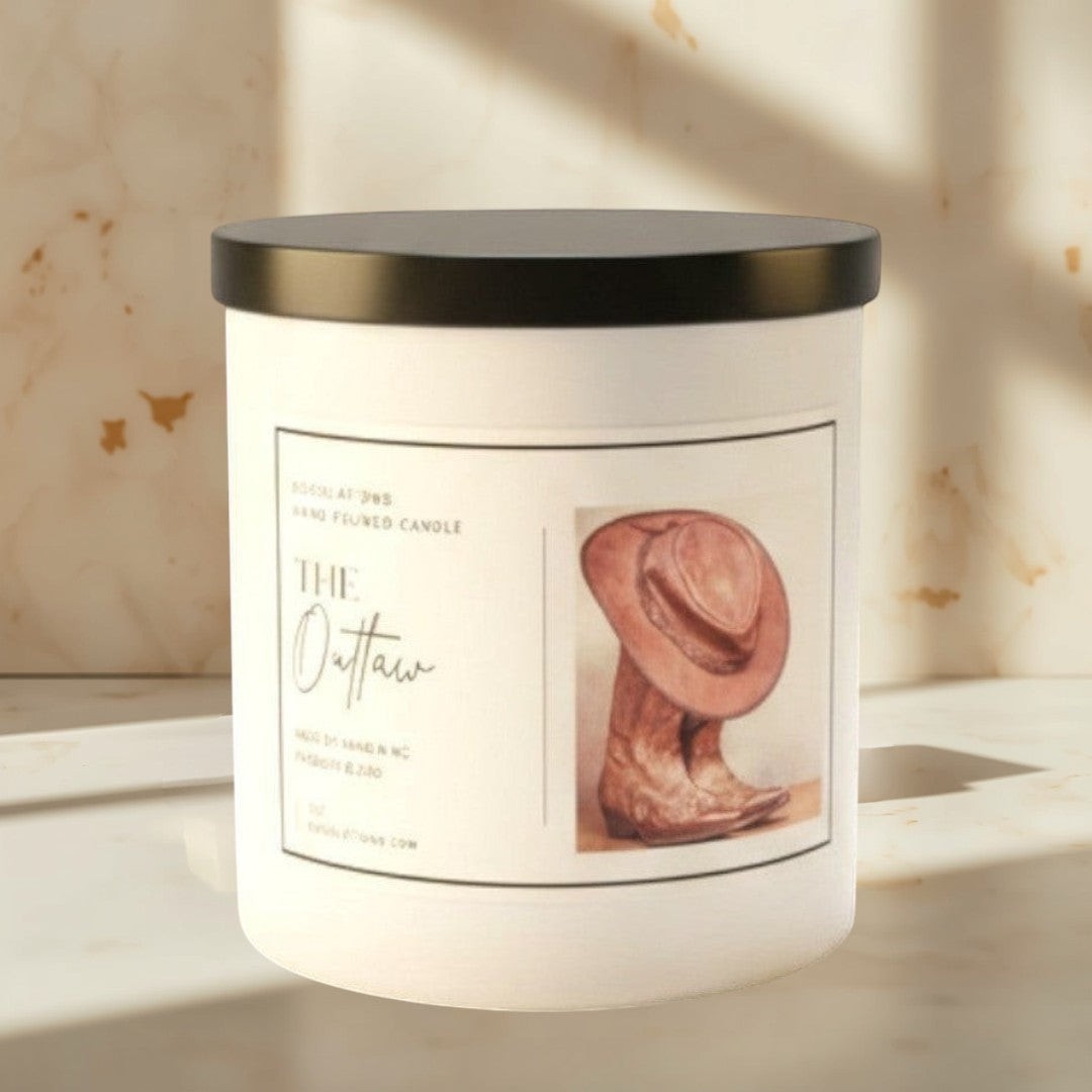 Doodlations Coffee Bar & Boutique The Outlaw luxury soy blend candle with cowboy hat and boots illustration. Masculine scent.